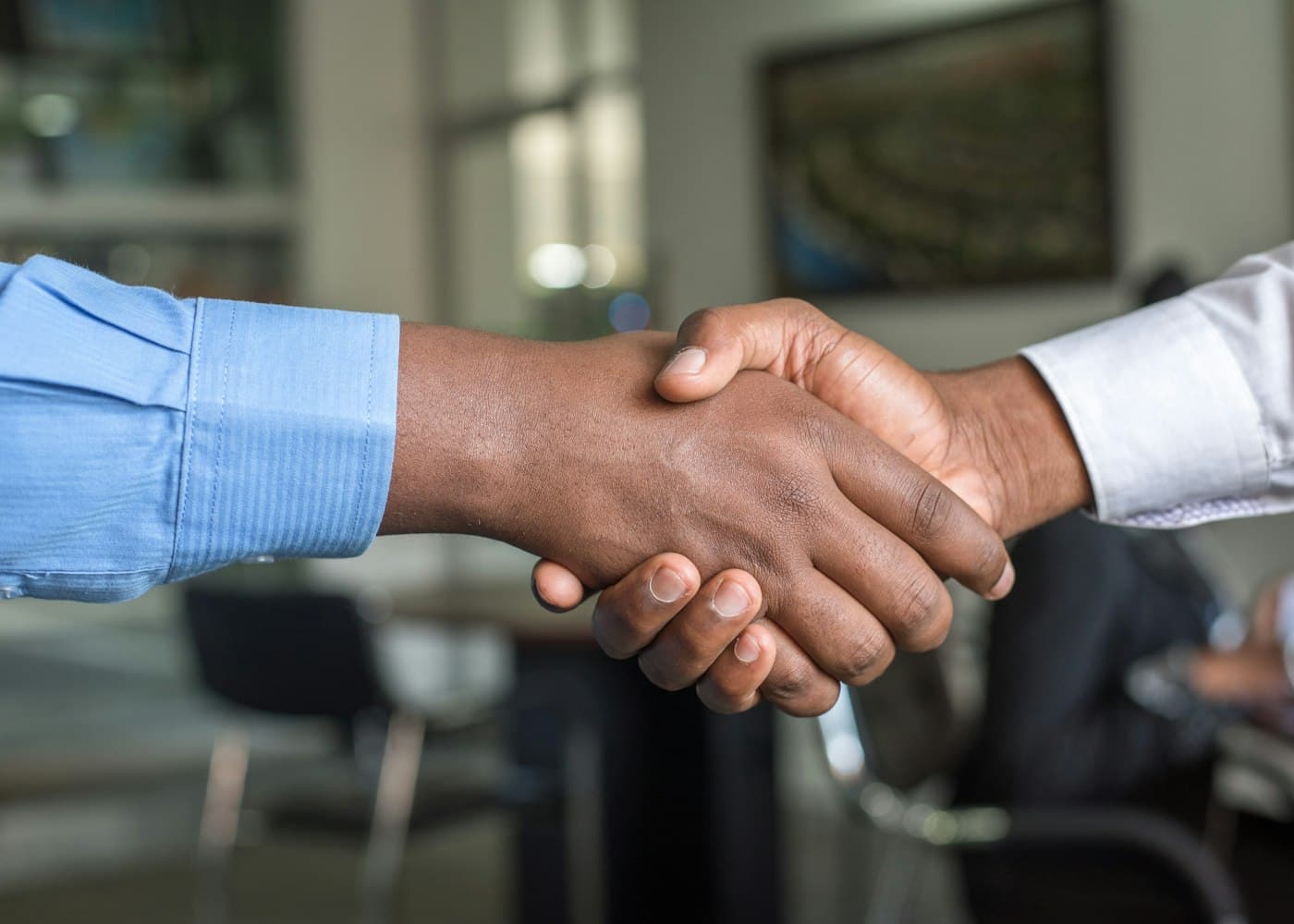 Two people shaking hands at the close of a meeting